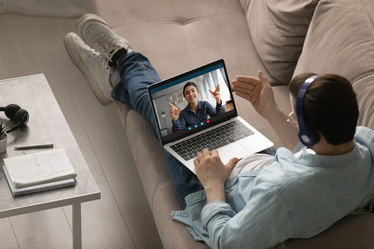 Person on couch during an online therapy video call